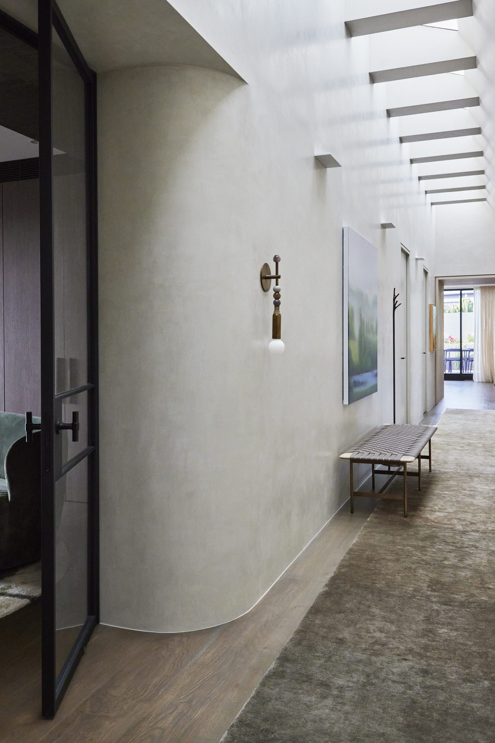 Skyline Penthouse corridor illuminated by full-length skylight by Hare + Klein