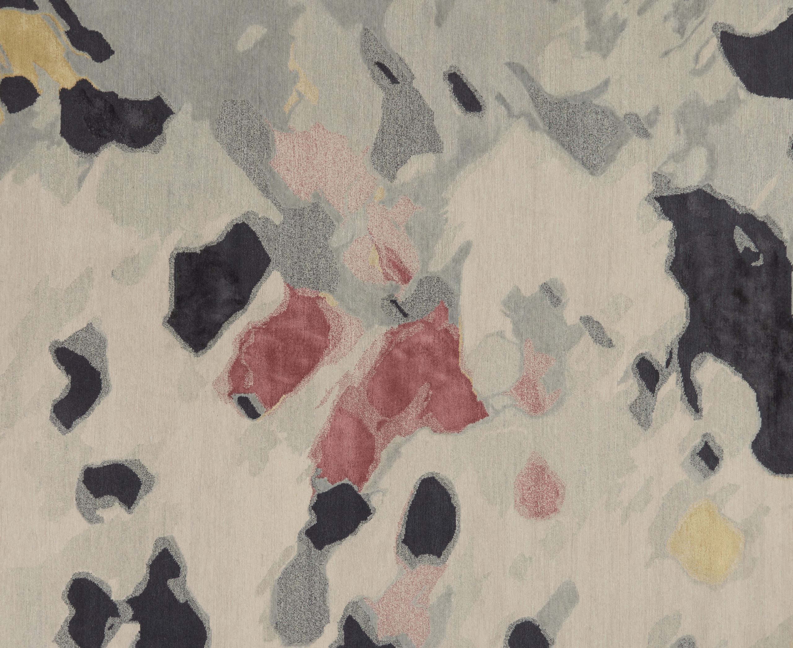 Close-up of Petale rug's pink and black floral-inspired pattern, design by Maddie Helyer