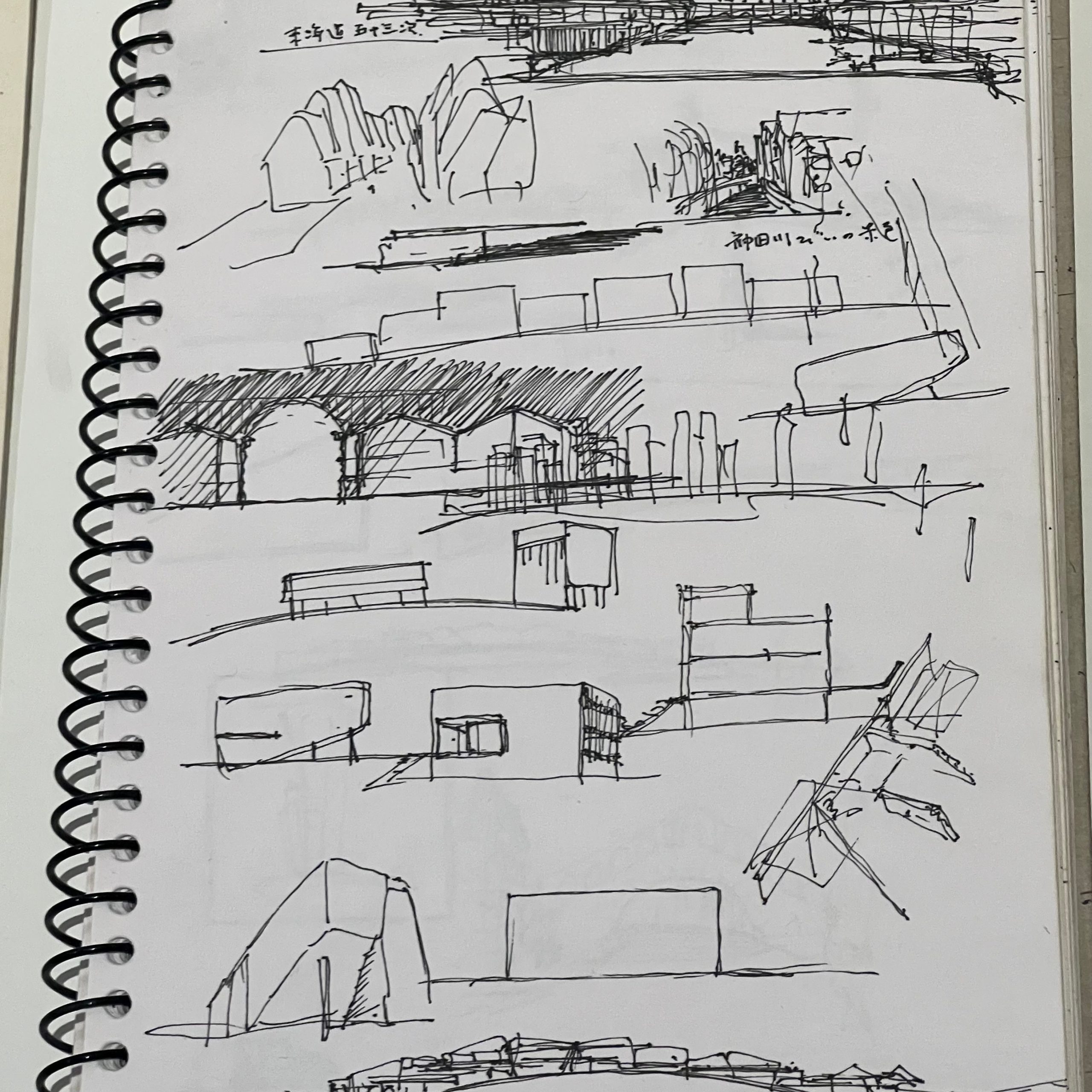 A page from Sou Fujimoto's sketchbook showing pencil concept drawings of architectural forms, on display at the exhibition.