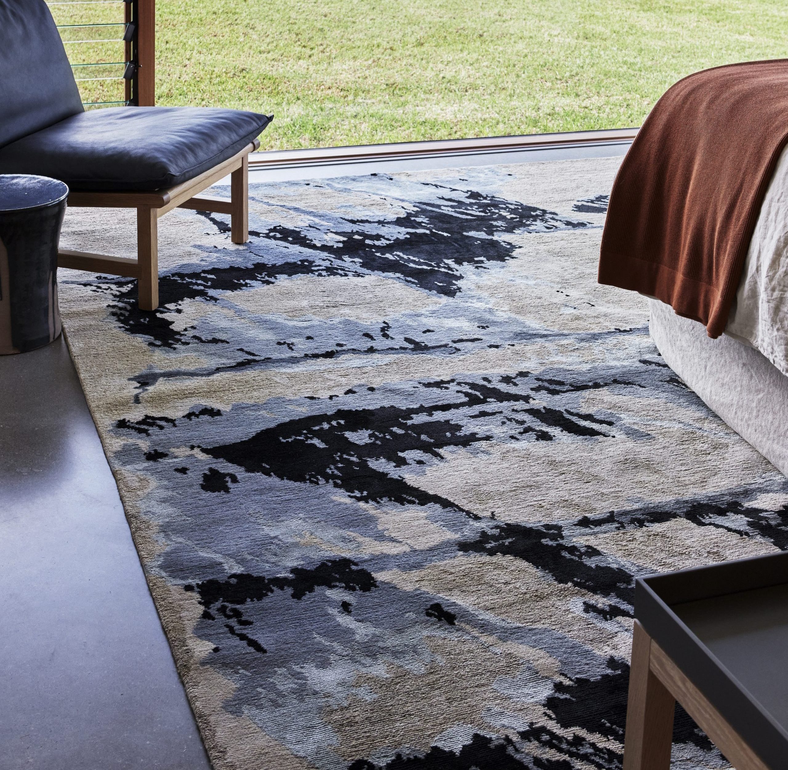Bedroom with Shores rug from the Hare + Klein x Designer Rugs fourth collection, large window to garden